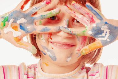 Sanat ve eğlence eğlence zamanı konsepti. Güzel bir çocuk portresi. Yüzü çocuk makyajı ve renkli eller..