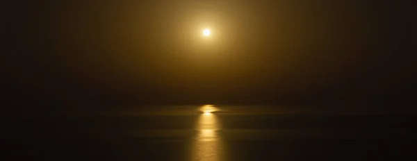 Long exposure photo. of fantastic night sea background. Moon reflecting in Mediterranean sea. Horizontal image.