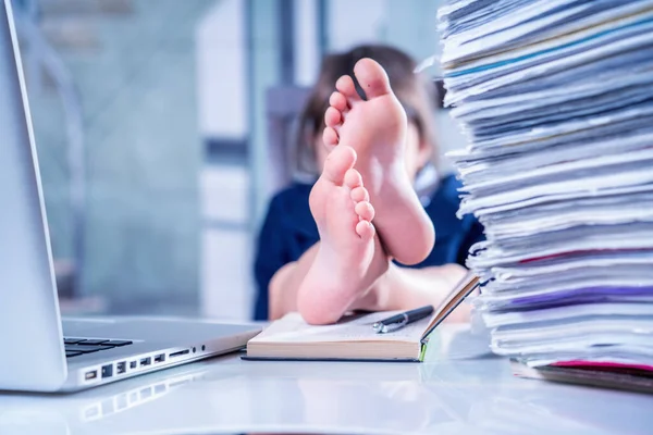 If You don\'t care about Your work, You lose it. Humorous photo of employee is resting instead of working. Selective focus on bare feet. Horizontal image.