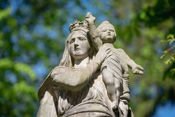 Queen of Heaven. Ancient statue of the Virgin Mary with Jesus Christ. Fragment of an ancient statue.