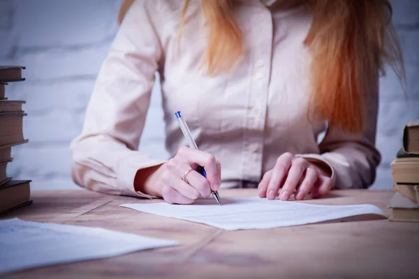 Beautiful business woman signing contract. Business, agreement, success, profit concept. Selective focus on hands. Horizontal image.