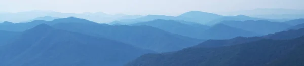 大雾中的深蓝色山景全景 横向图像 有选择的重点 — 图库照片