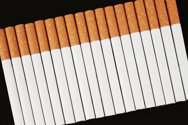 Cigarette on a black background — Stock Photo, Image