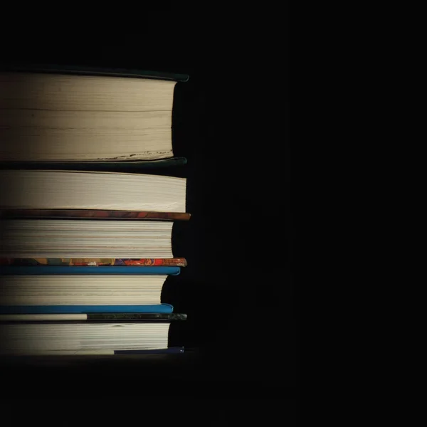 Stack of books on the black background — Stock Photo, Image