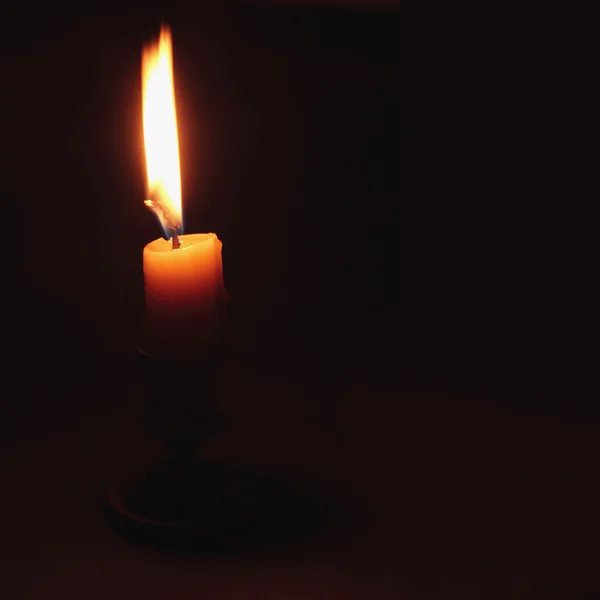 Fire candle on a dark background — Stock Photo, Image