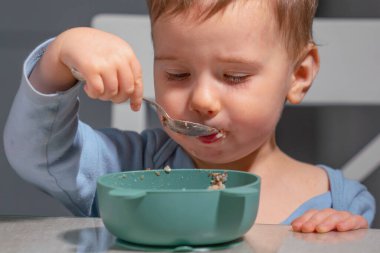 Erken çocukluk beslenmesi bağımsız yulaf ezmesi yiyerek gösterilir.