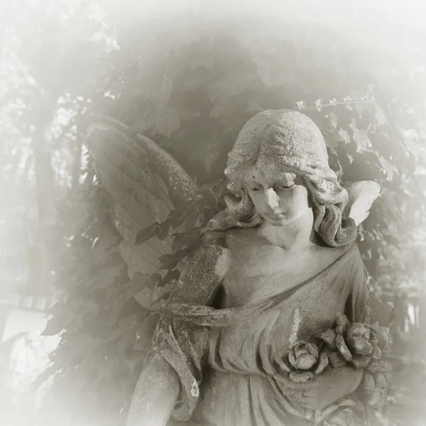 Vintage image of a sad angel on a cemetery against the backgroun — Stock Photo, Image