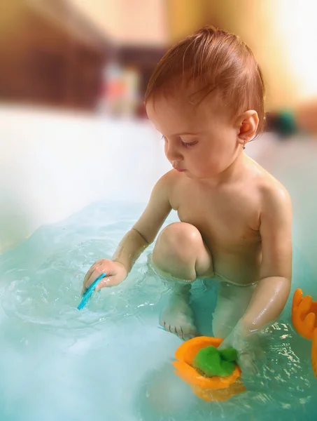 Beautiful baby is playing in the bathroom — Stock Photo, Image