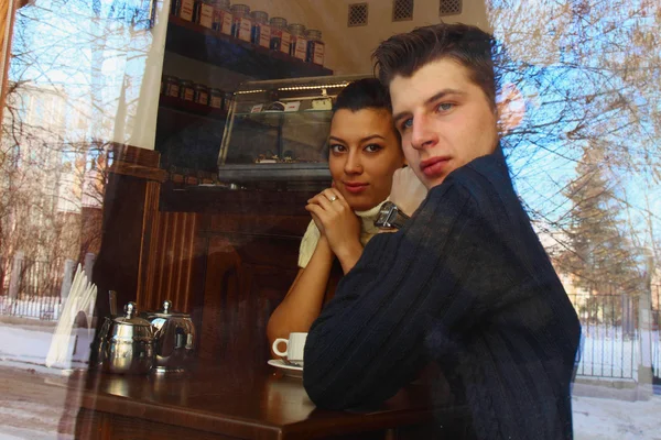 年轻的夫妇在咖啡馆，查看通过一个窗口 — 图库照片