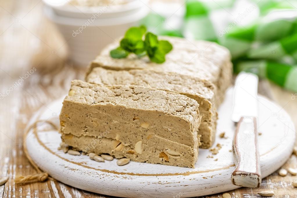 Sliced halva on a board Stock Photo by ©yelenayemchuk 102390466