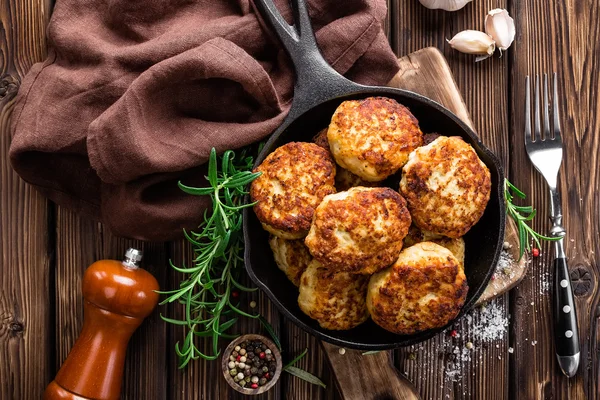 Meat cutlets on frying pan — Stock Photo, Image