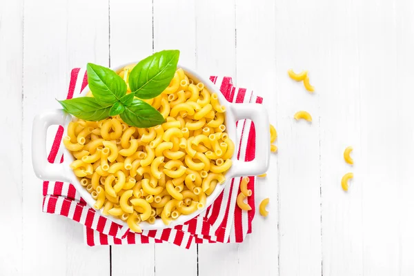 Raw pasta in a bowl — Stock Photo, Image