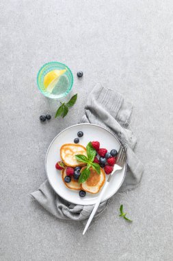 Sağlıklı vejetaryen kahvaltısı için taze yaban mersinli ve ahududulu krep.