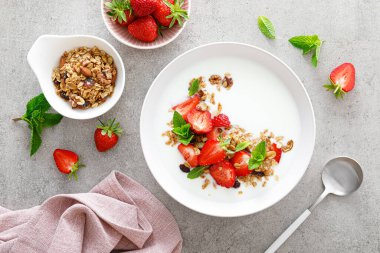 Strawberry granola with greek yogurt, nuts and fresh berries for breakfast, top view