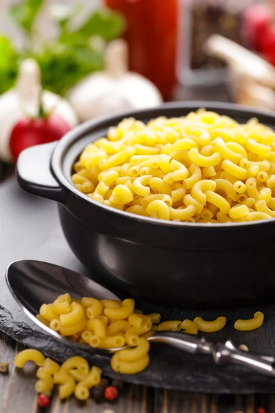 Raw pasta in a bowl — Stock Photo, Image