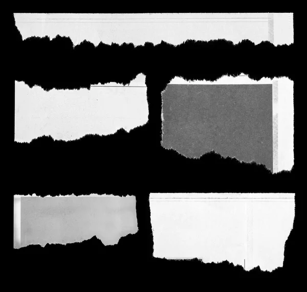 Torn papers on black — Stock Photo, Image