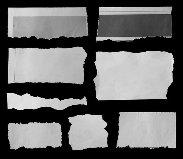 Roztrhané papíry na černém pozadí — Stock fotografie