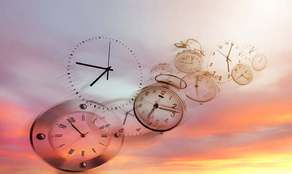 Three clocks in bright sky. Time passing