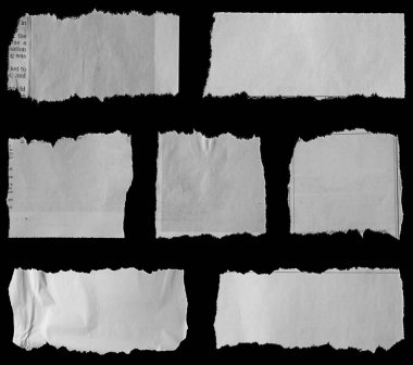 Siyah arka planda yedi parça yırtık gazete