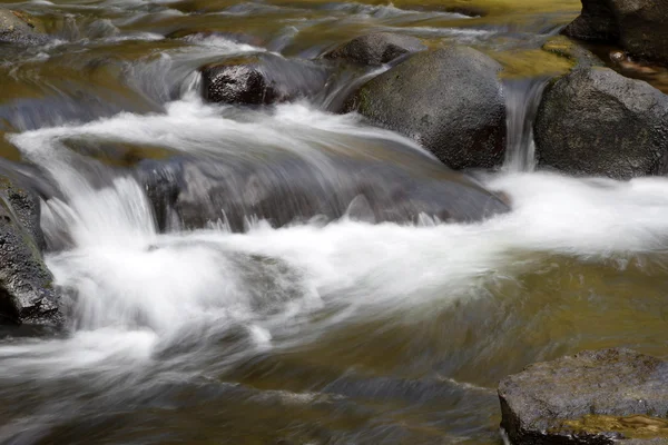 Voda tekoucí přes skály — Stock fotografie