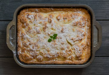 Kremalı ve süzme peynirli çörekli turta ahşap bir masada kırsal tarzda doluyor.