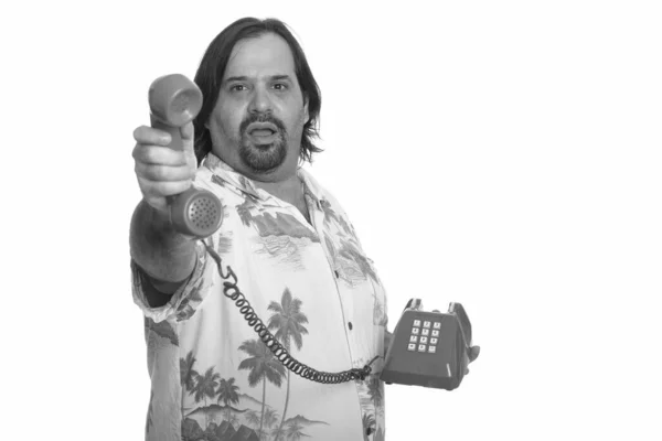 Fat Caucasian man passing call from old telephone — Stock Photo, Image