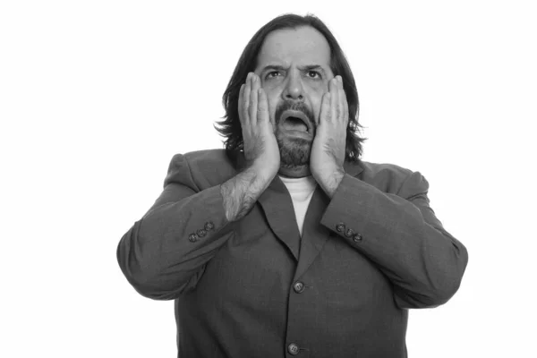 Portrait of stressed overweight bearded businessman in suit looking scared — Stock Photo, Image