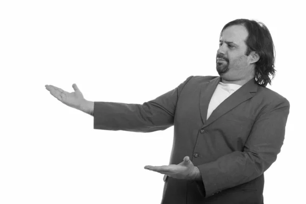 Portrait of overweight bearded businessman in suit showing something — Stock Photo, Image