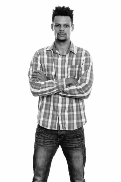 Studio shot of young African man standing with arms crossed — Stock Photo, Image