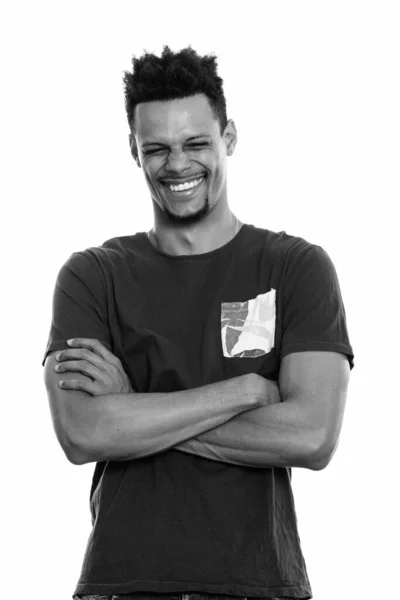 Studio shot of young happy African man smiling with arms crossed and eyes closed — Stock Photo, Image