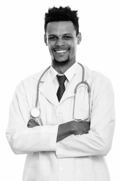 Young happy African man doctor smiling with arms crossed — Stock Photo, Image