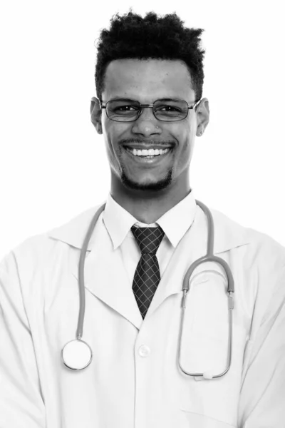 Young happy African man doctor smiling while wearing eyeglasses — Stock Photo, Image