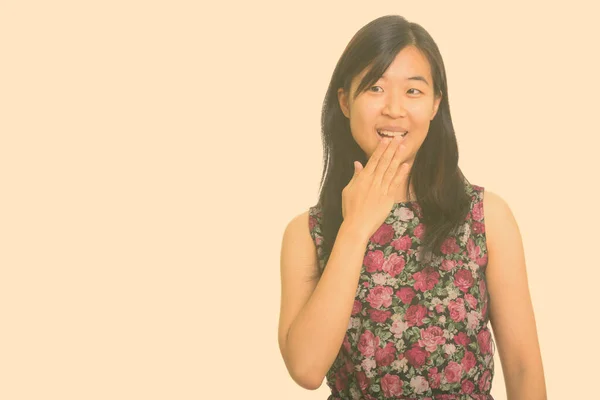 Jovem mulher asiática feliz cobrindo a boca enquanto ri — Fotografia de Stock