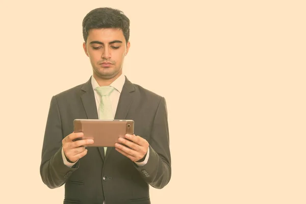 Young handsome Persian businessman holding digital tablet — Stock Photo, Image