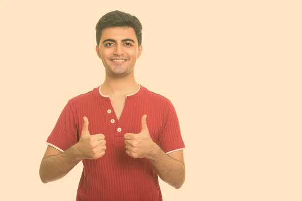 Young happy Persian man giving thumbs up — Stock Photo, Image