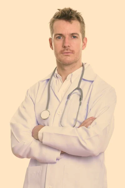 Studio shot of man doctor with arms crossed — Stock Photo, Image