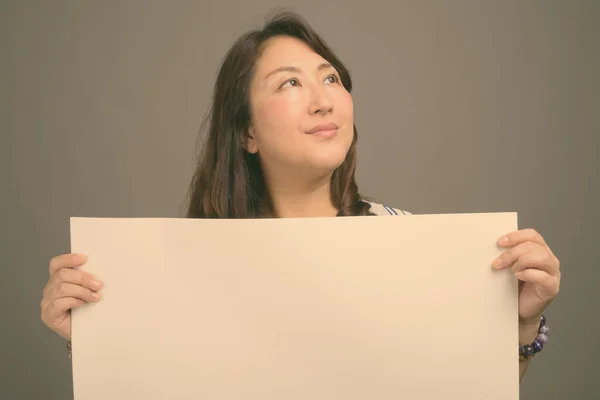 회색 배경에 대항하는 아름다운 아시아 여성 성숙기 — 스톡 사진