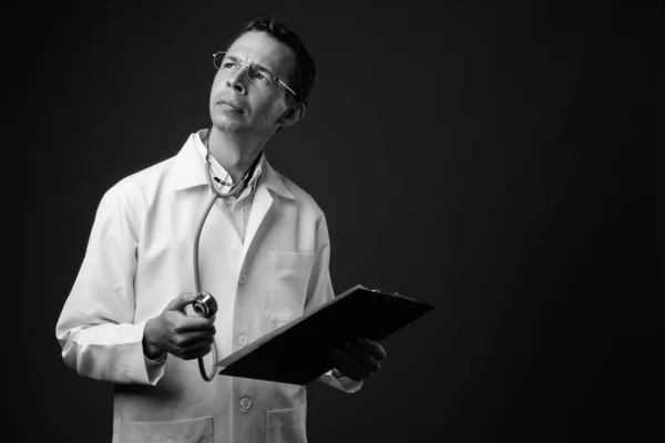 Studio shot of man doctor against gray background — Stock Photo, Image