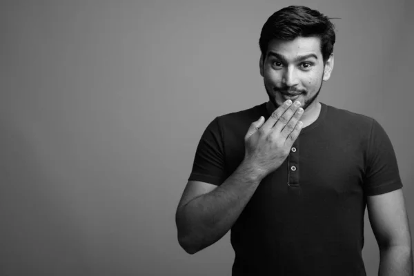 Joven guapo barbudo persa hombre sobre fondo gris — Foto de Stock