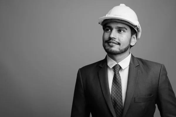 Ung stilig skäggig persisk affärsman bär hatt mot grå bakgrund — Stockfoto