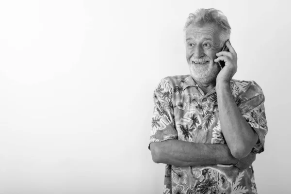 스튜디오는 하얀 배경 과 핸드폰으로 통화하면서 행복 한 노인이 웃으며 생각하는 모습을 촬영했다. — 스톡 사진