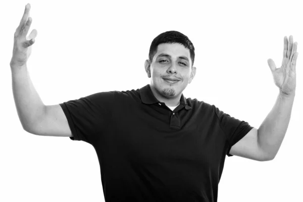 Studio shot of young Hispanic man with open arms — Stock Photo, Image