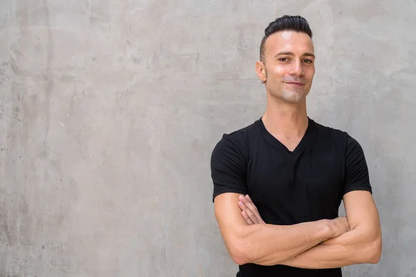 Portrait of happy young Italian man with undercut wearing black t-shirt — Stock Photo, Image