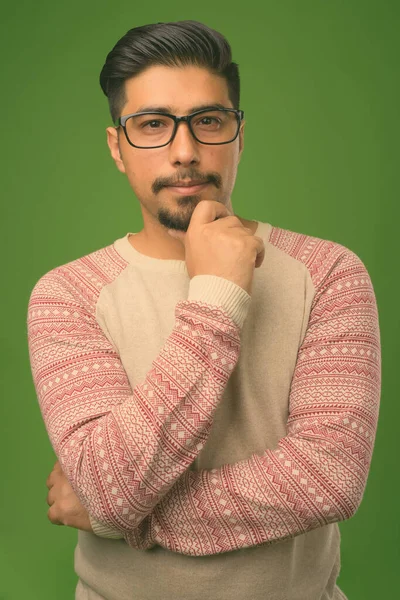 Jonge bebaarde Iraanse man tegen groene achtergrond — Stockfoto