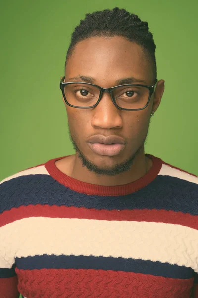 Young handsome African man from Kenya against green background — Stock Photo, Image