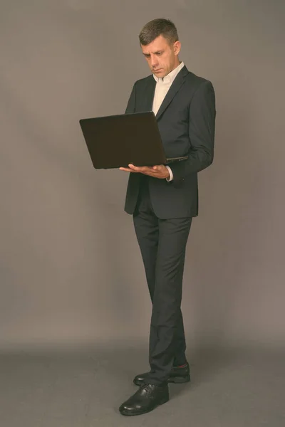Bello uomo d'affari con i capelli corti sullo sfondo grigio — Foto Stock