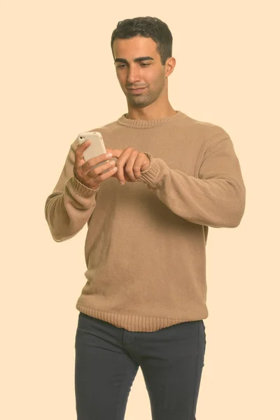 Young handsome Iranian man using mobile phone — Stock Photo, Image