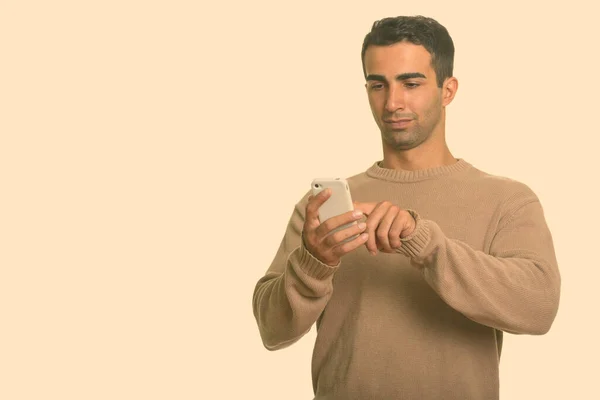 Young handsome Iranian man using mobile phone — Stock Photo, Image