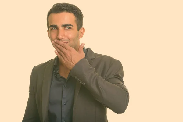 Young happy Iranian businessman giggling