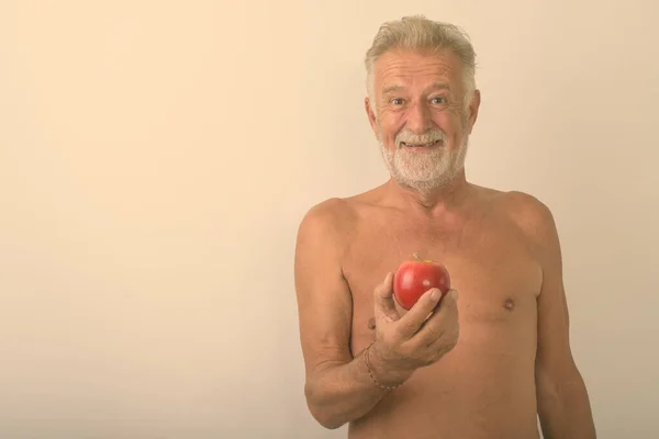 Estúdio Tiro Homem Barbudo Sênior Feliz Sorrindo Enquanto Segurando Maçã — Fotografia de Stock